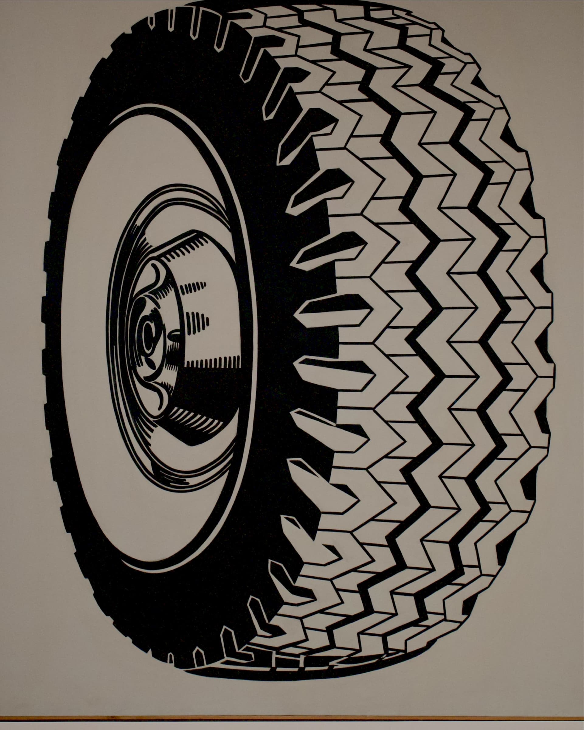 A tire drawn in black lines inside a white frame