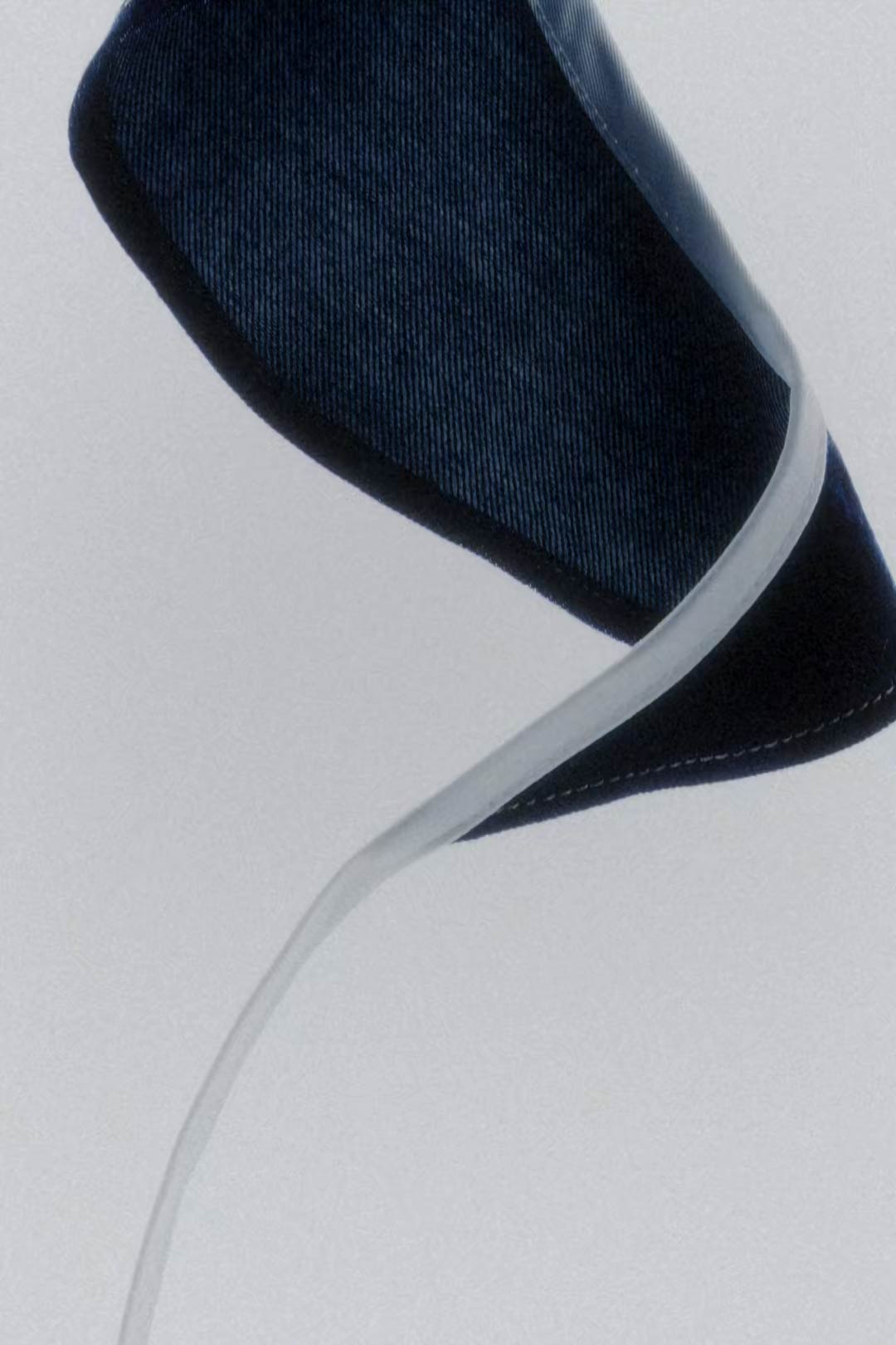 Sculpted dark denim with a clear binding, from the Acne Studios Hussein Chalayan capsule