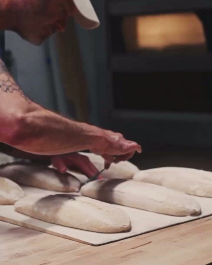 A baker shaping baguettes at Altbau