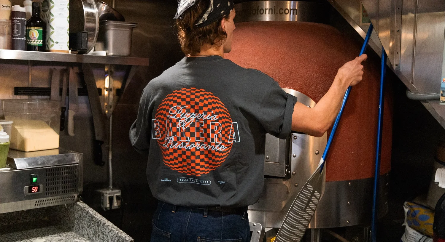 Balera pizza oven with a cook in a Balera T-shirt