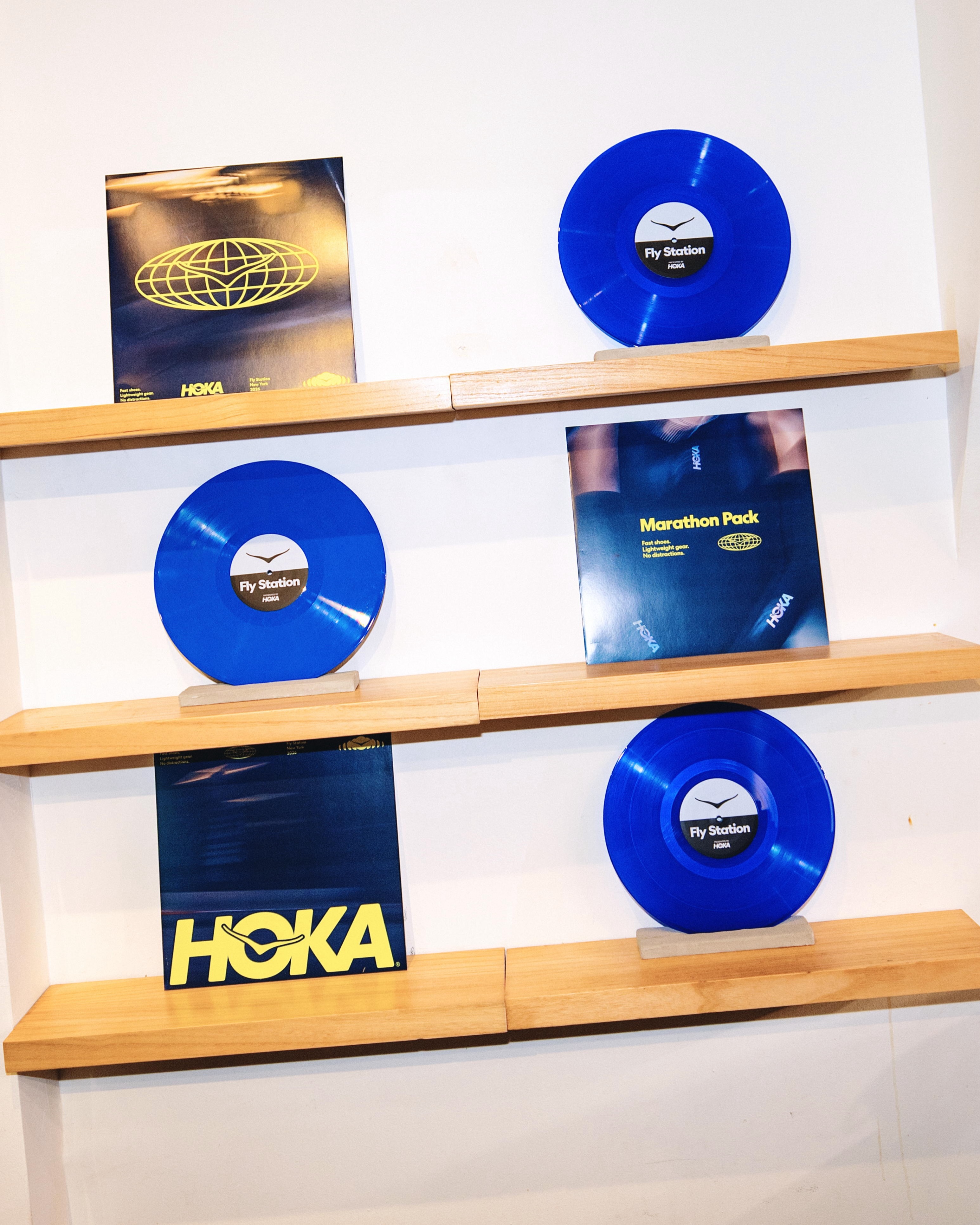 Blue Fly Station vinyl records and Marathon Pack sleeves on wooden shelves