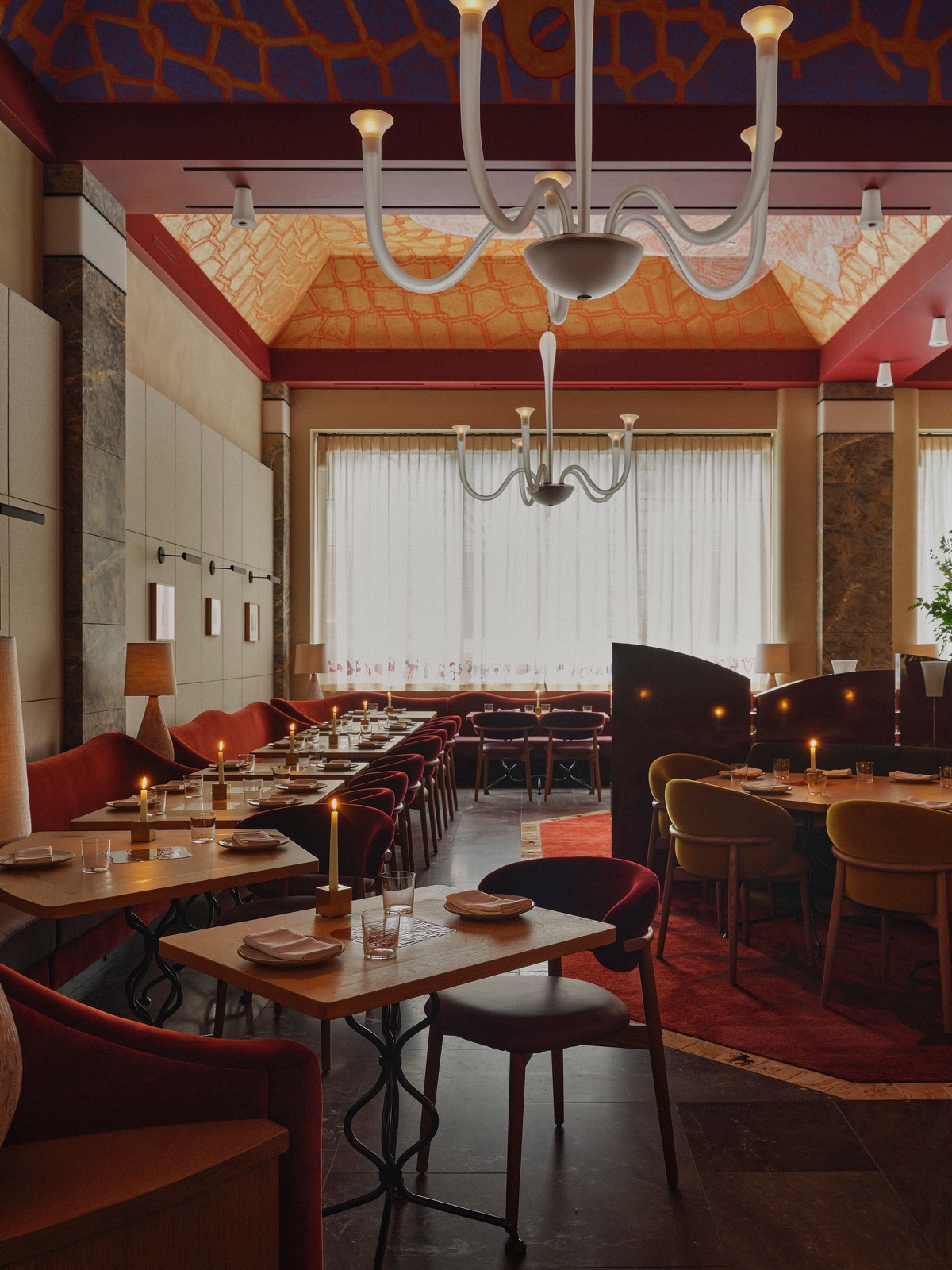 HUMM dining room with candlelit tables and a painted ceiling