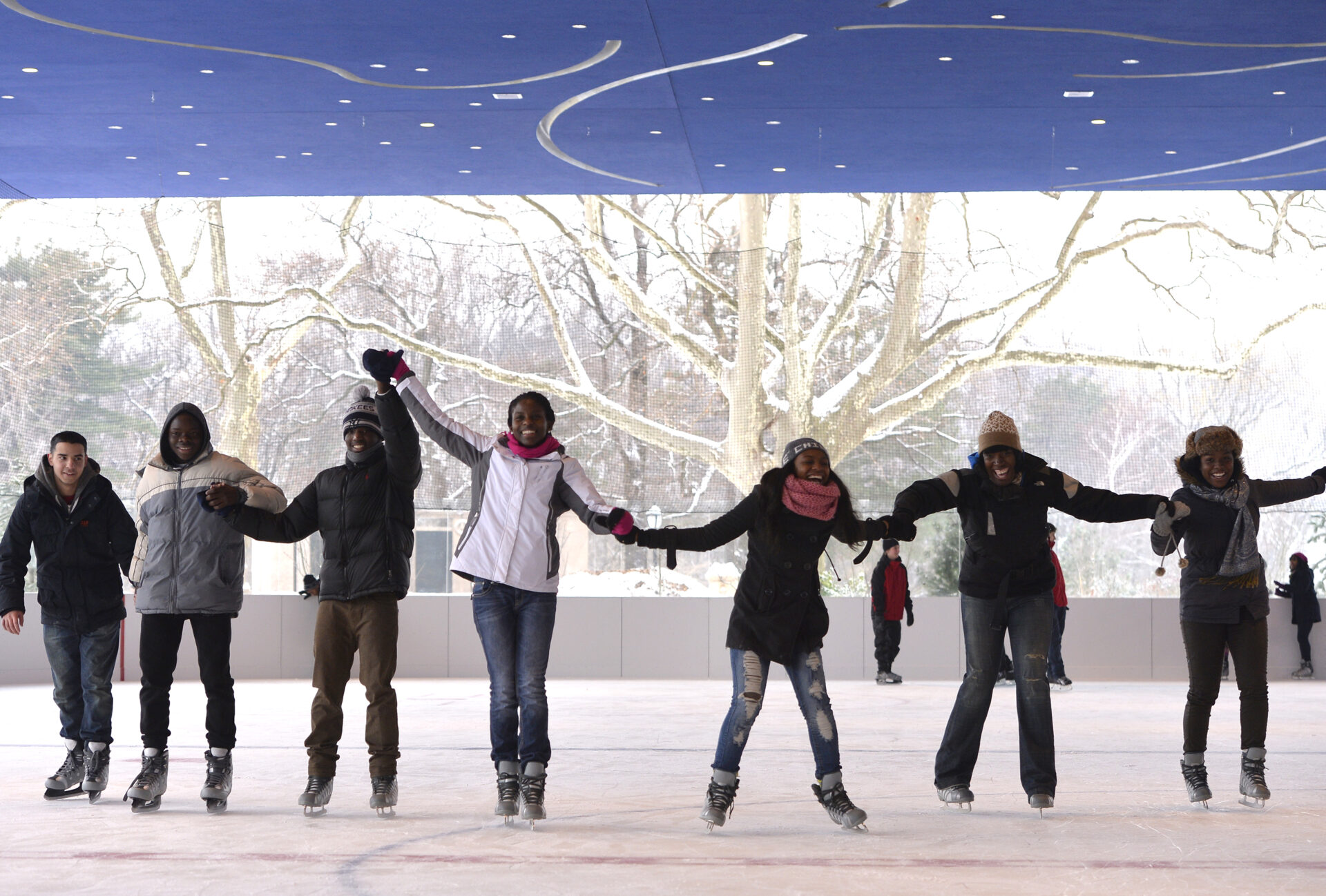 Skaters holding hands on the covered rink at Lakeside
