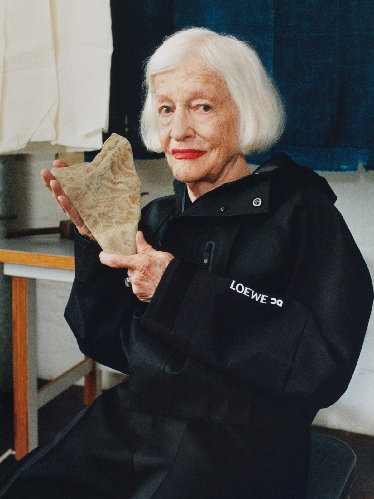 Artist wearing a black LOEWE x On hooded jacket