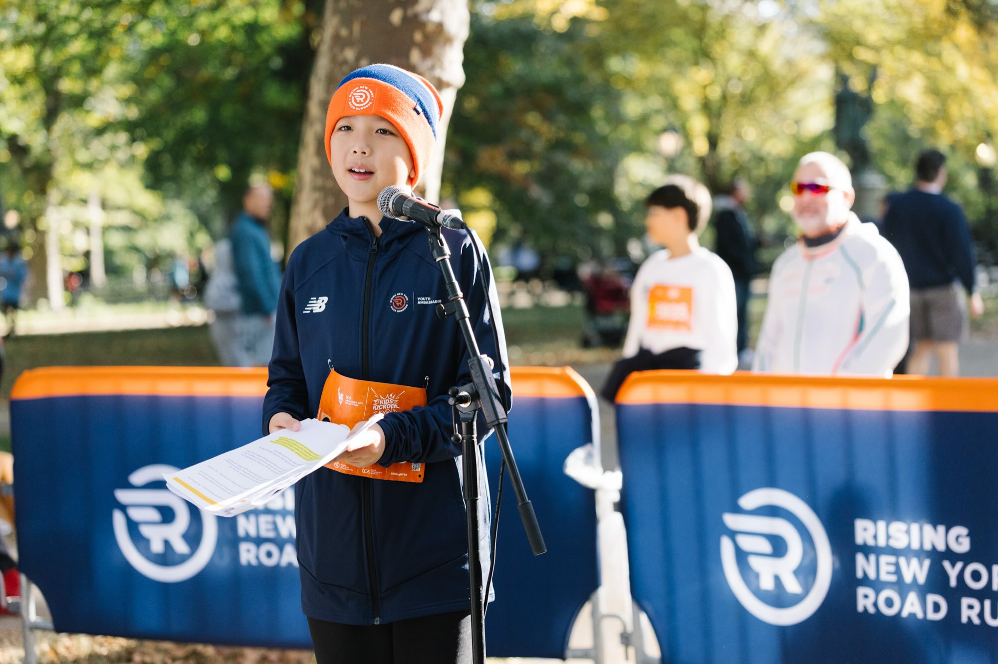A youth ambassador speaking at the microphone at the Kids Kickoff in Central Park