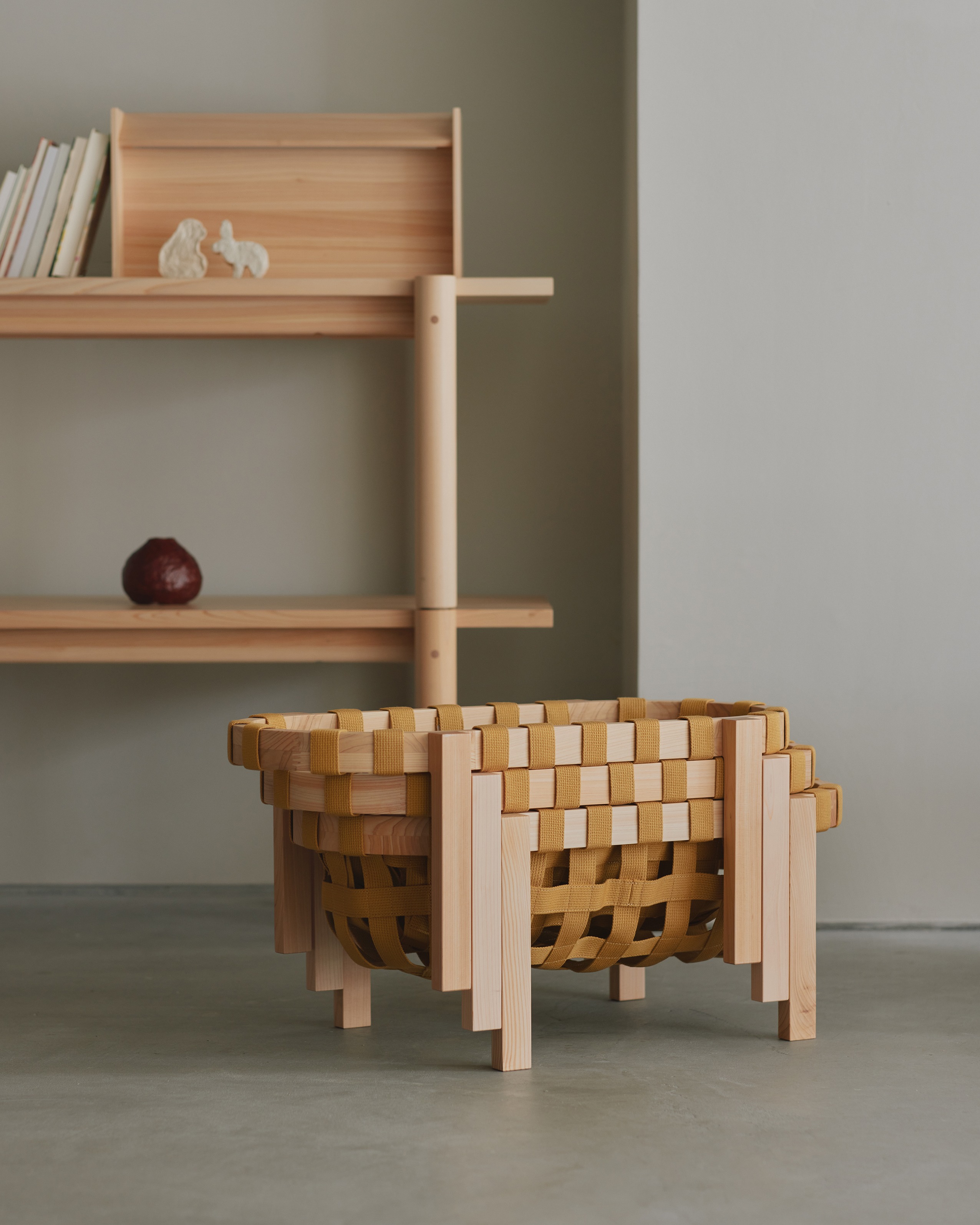 SF Basket 01 stacked baskets with wooden legs in front of a cypress shelf