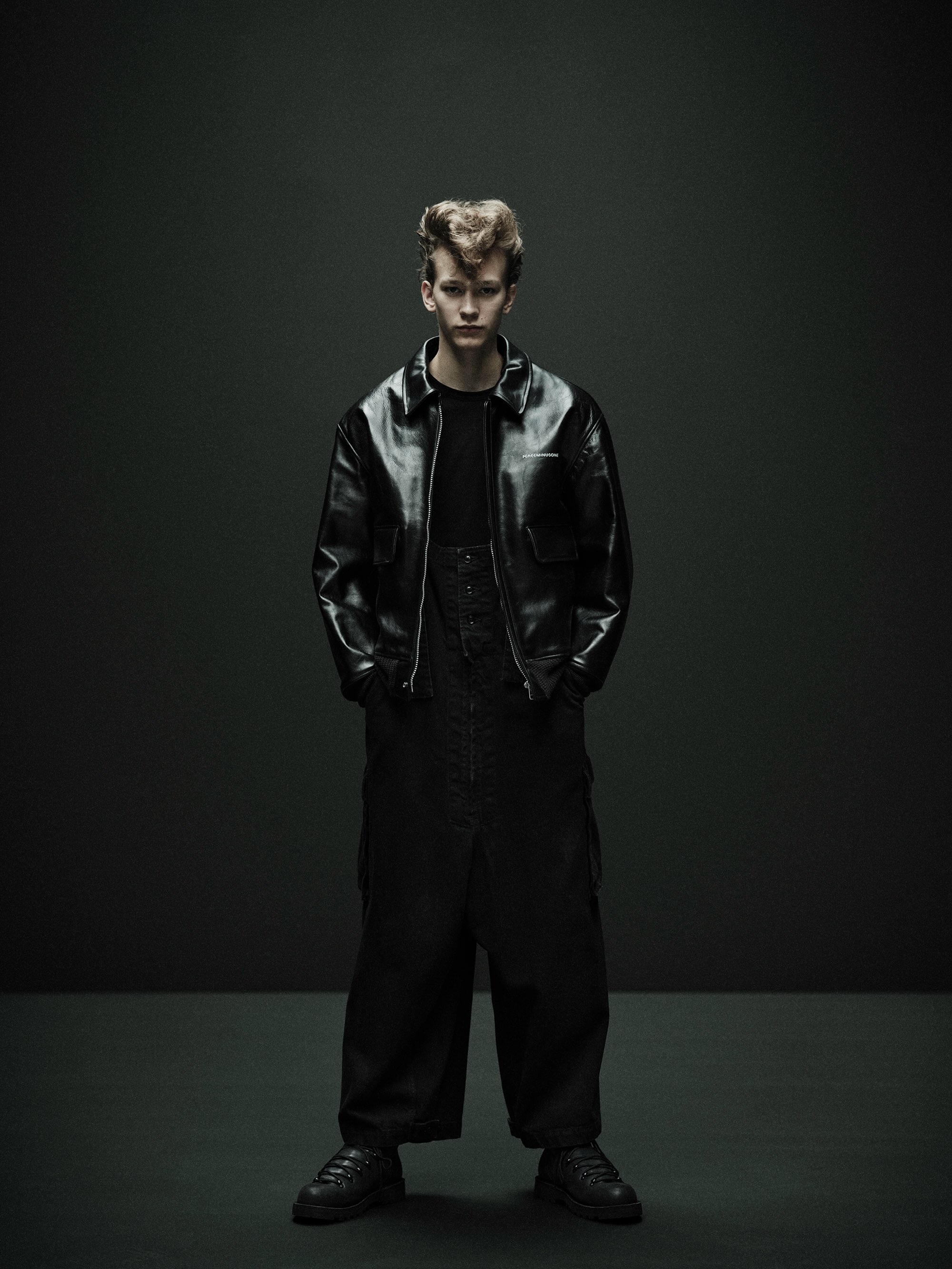 Model in the black leather jacket with flap pockets and ribbed hem