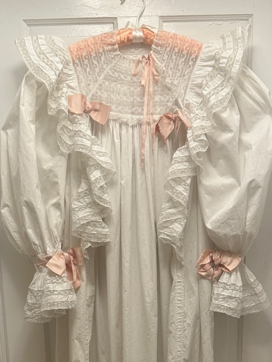 White cotton nightgown with lace ruffles and pink ribbon bows