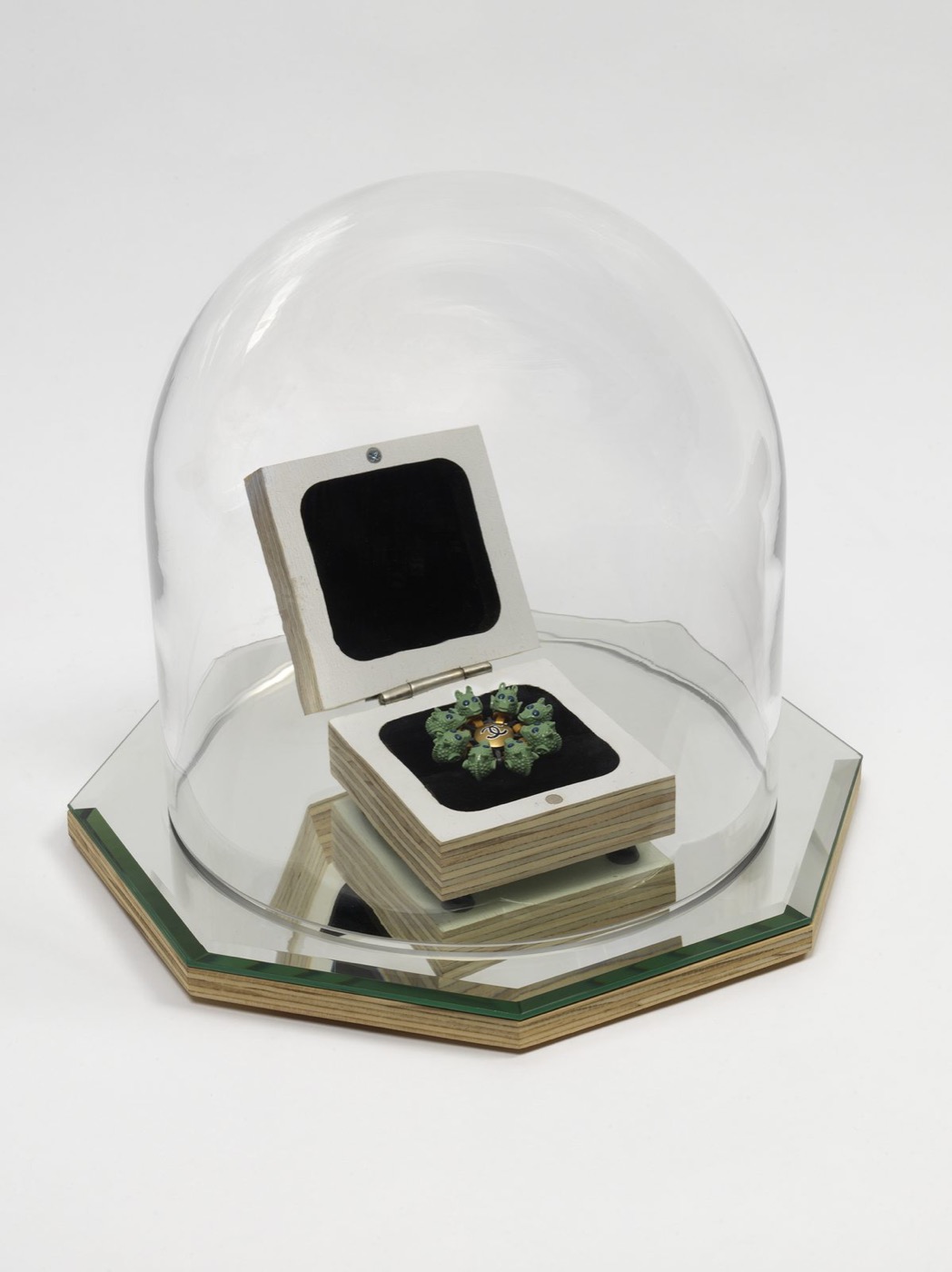 A handmade object under a glass dome